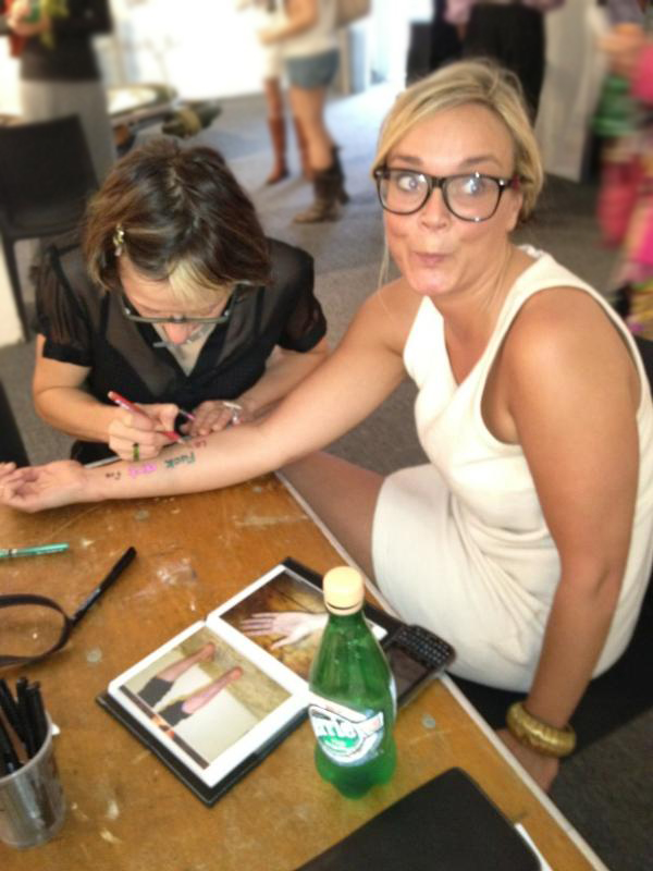 Natascha pen tattoos Hilary at Pulse Miami 2011