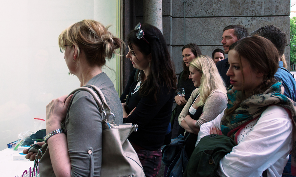 Viewers watch Natascha Stellmach's inkless tattoo happening at Wagner+Partner Berlin, 2013, photo by Oli Parzer